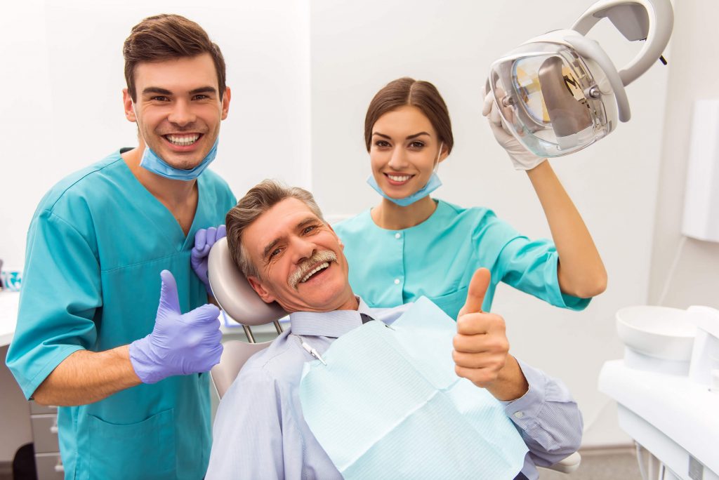 Dentist consulting with smiling patient