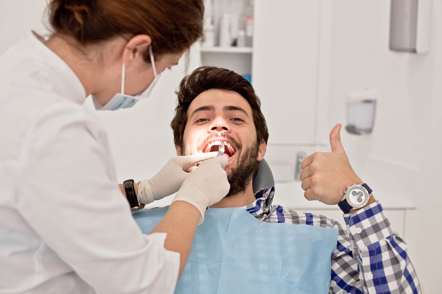 Dentist examining patient smile