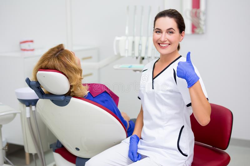 Patient checking teeth at dental consultation